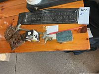 Overall lot on tabletop showing handles, broken sign, gas light fixture, Higgins ink box, fountain pen, nib tin