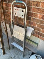 Ladder folded against wall showing full front profile
