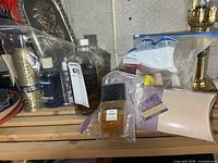 Overall lot on shelf showing all bottles and bagged items