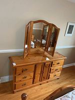 Front view of dresser with attached trifold mirror