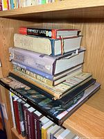 Stack of seven large religious books on shelf