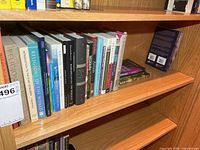 Full view of fourth shelf showing majority of religious books