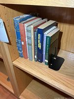 Eight religious books on shelf, full view