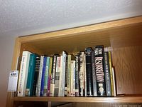 Full width of the top shelf showing entire run of books