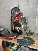 Overall lot showing rooster, sconces, stacked pottery pieces