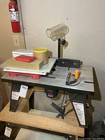 Front view of Ryobi router table, stand, fence, guard, and power unit visible