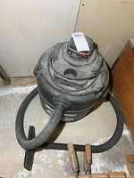Top and side view of Shop-Vac with attached hose