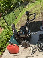 Full view of Craftsman snowblower and red fuel can