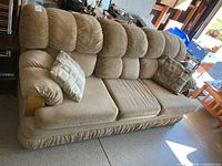 Front view of beige micro suede sofa with two throw pillows