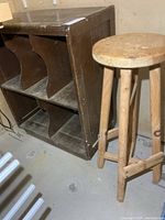Stool beside cubby cabinet showing overall design and scale