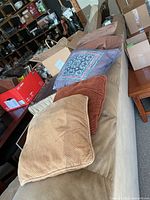 Group shot of multiple throw cushions resting on sofa