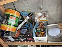 Overview of lot on shelf including Animal Planet bucket, massager box, small clock, magnets, and additional toys