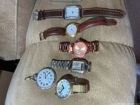 All six timepieces laid out showing overall styles and condition