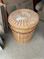 Full view of wicker hamper with lid and side handle
