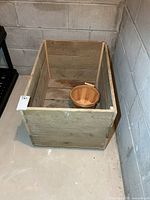 Top view of wooden crate interior with basket inside