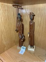 Both wood figures displayed on shelf
