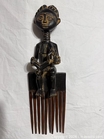 Full view of Ashanti duafe comb with figure and tines