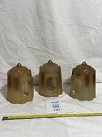 Full view of all three matching glass slip shades with measuring tape for scale