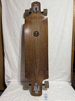 Full view of the complete longboard showing deck, trucks, and wheels