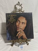Front cover of Bob Marley Legend vinyl LP on stand