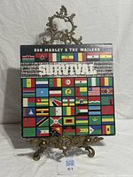 Front of Survival album jacket with flag artwork and artist/title