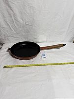 Full view of Le Creuset skillet with tape for scale