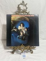 Front cover of American Woman LP on stand