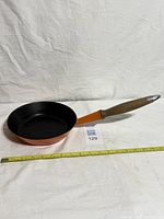 Full view of skillet with tape measure for scale