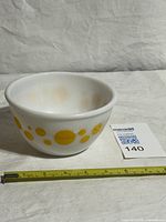 Side view showing polka dot design and size reference