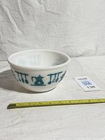 Side view of bowl showing teal Kitchen Aids pattern and ruler indicating diameter