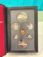 Front view of seven-coin proof set in holder