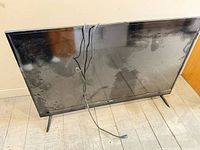 Front view of RCA television with attached power cord and leg stands