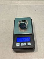 Ring on scale showing 12.30 g weight