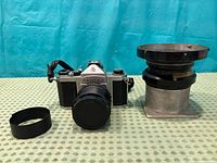 Front view of Pentax S1a camera with lens, separate Kodak Aero-Ektar lens and rubber grip ring
