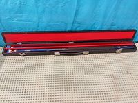 Full view of cue assembled in open hard case