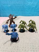 Group shot of all eight miniatures on cloth backdrop