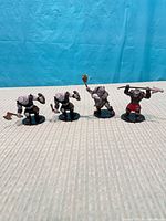 Front view of four cyclops miniatures in a row