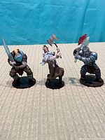 Three Frost Giant miniatures on bases, full view