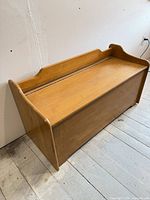 Overall front view of wooden storage bench