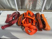 Group of five ratchet straps laid out on table