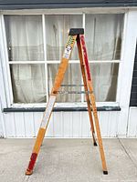 Front view of orange fiberglass ladder