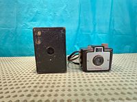 Front view of Kodak No.2A box camera beside Kodak Brownie Holiday camera