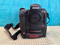 Front view of Kodak Professional DCS 720x Nikon F5 camera body with strap attached