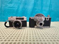 Front view of both Konica C35 and Mercury Model CX cameras
