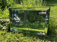Front view of rectangular bevelled mirror outdoors