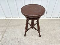 Full view of brown wood swivel stool