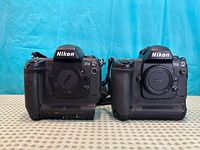 Front view of both Nikon D1X bodies showing mounts, caps and wear