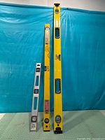 Front view of three spirit levels standing upright