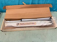 Box opened showing folded Reflectasol-Hex system with aluminum rods
