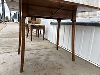 underside and leg view of walnut drop leaf table